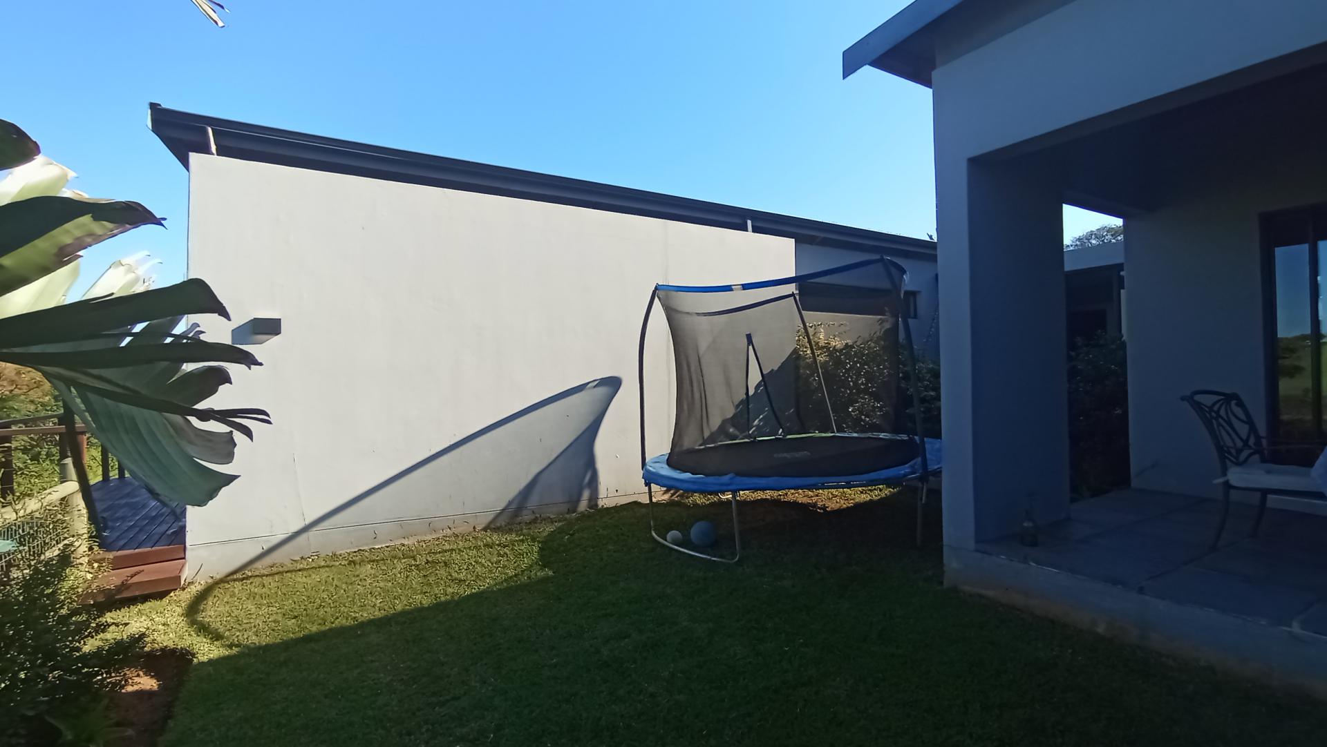 Backyard of property in Palm Lakes Family Estate